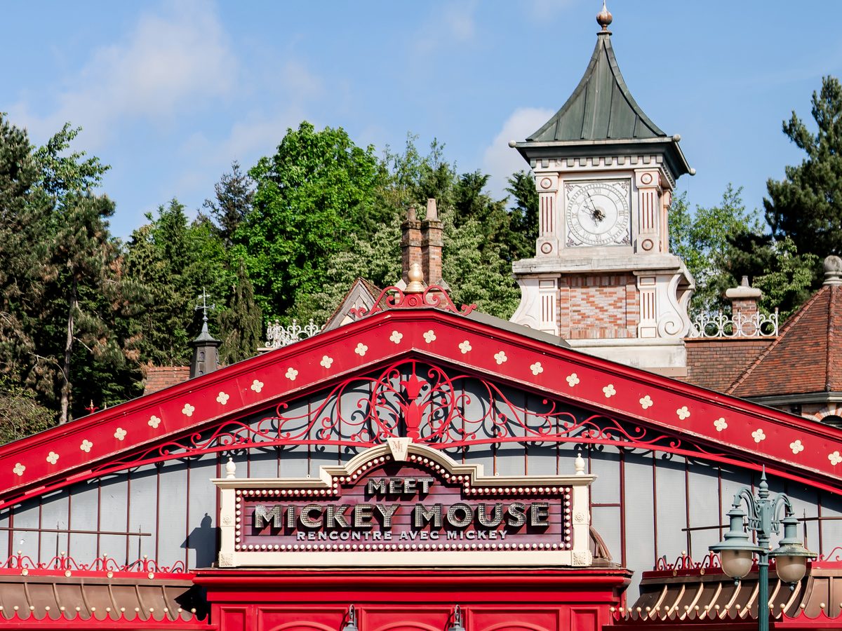 The red ironwork roof and Meet Mickey Mouse marquee of the pavilion in Fantasyland