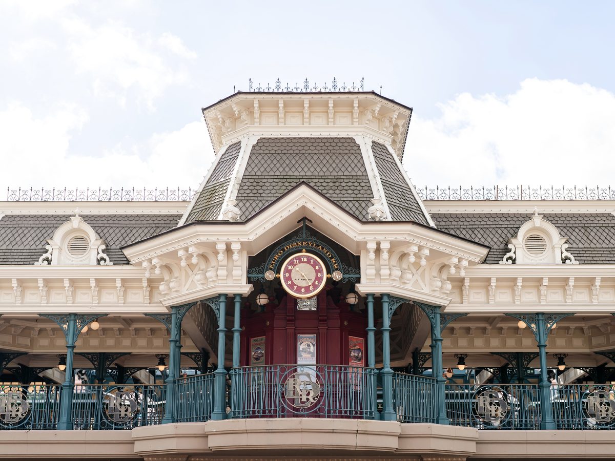The ornate Victorian-style Disneyland Railroad station clock tower at the entrance of Main Street U.S.A.