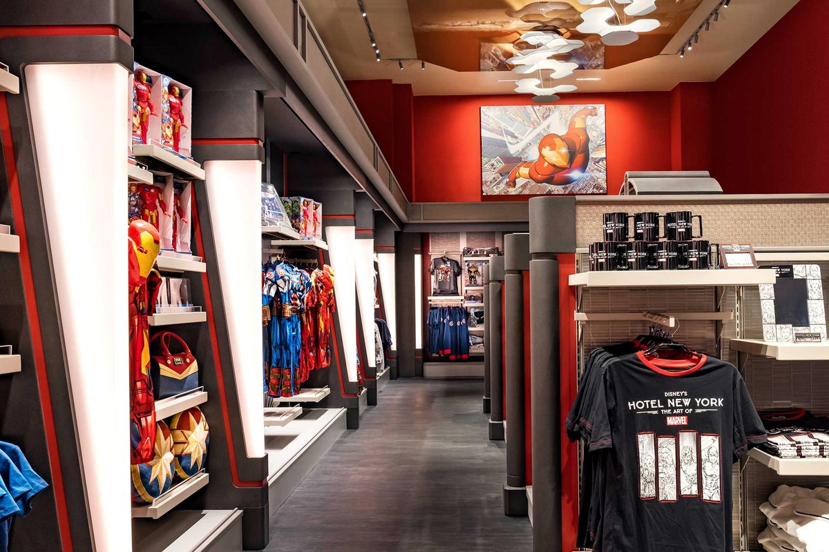 The New York Boutique, shelves of Marvel toys and costumes with Hotel New York The Art of Marvel t-shirts and mugs