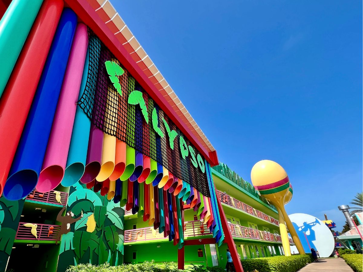 The Calypso building at Disney All-Star Music, its walkway hung with giant rainbow pipes beside a three-storey maraca