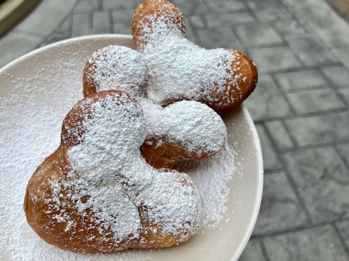 Mickey-shaped beignets dusted with icing sugar on a plate at Disney's Port Orleans French Quarter