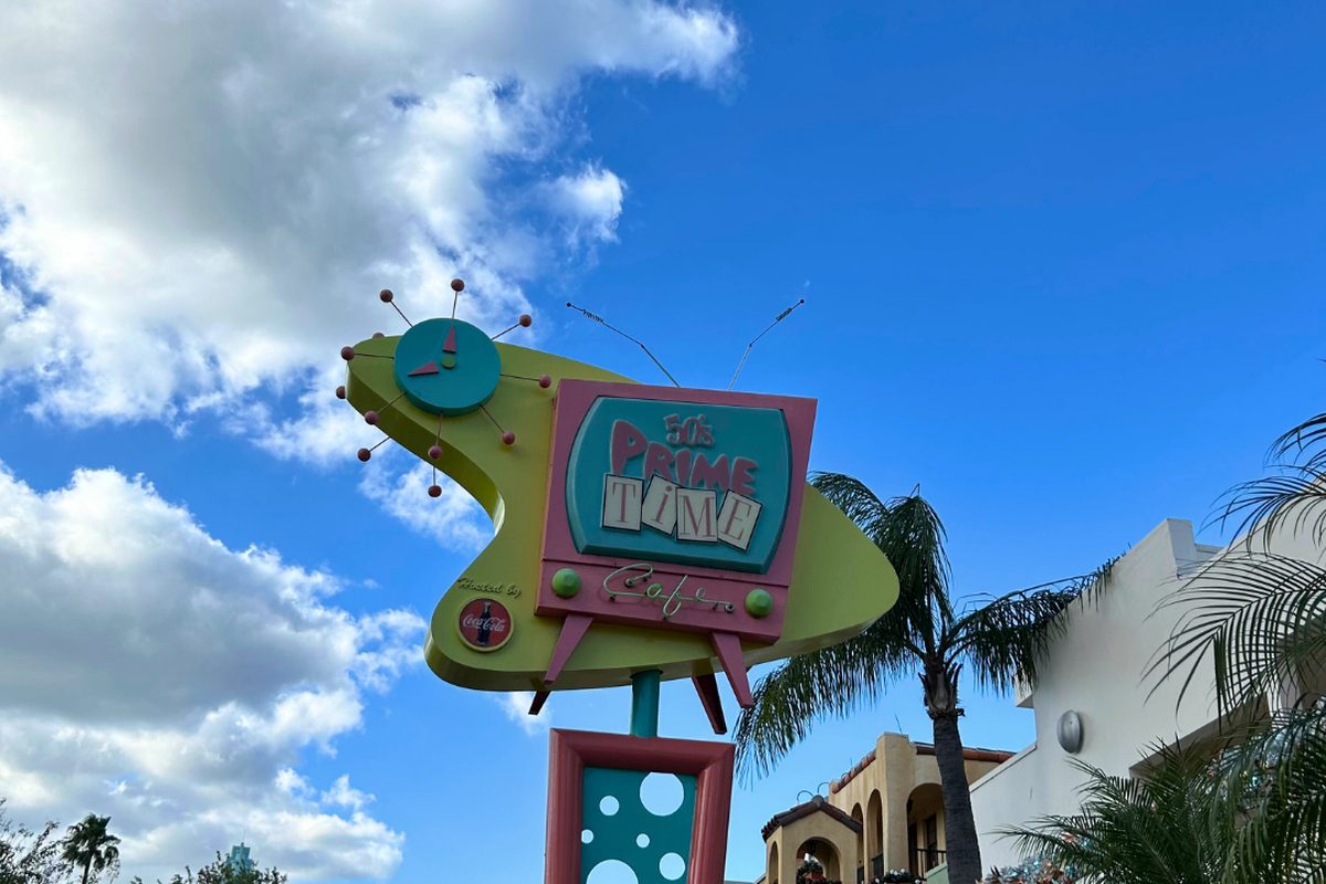 The roadside sign of 50's Prime Time Café at Echo Lake against a blue sky