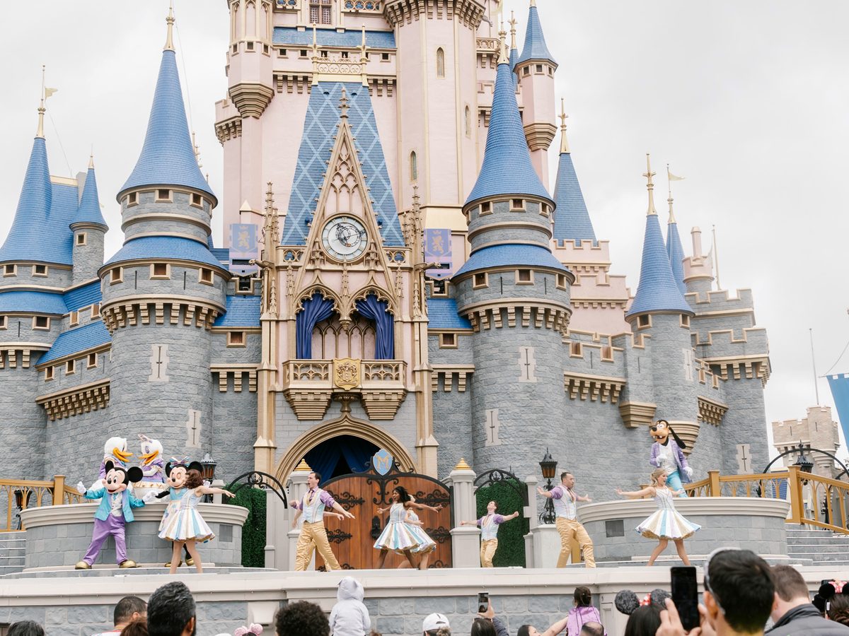 Mickey, Minnie, Donald, Daisy, Goofy and dancers performing Mickey's Magical Friendship Faire on the stage in front of Cinderella Castle