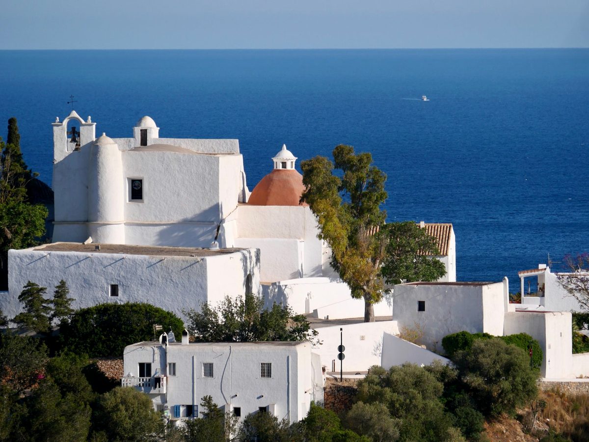 A whitewashed hilltop church above the coast