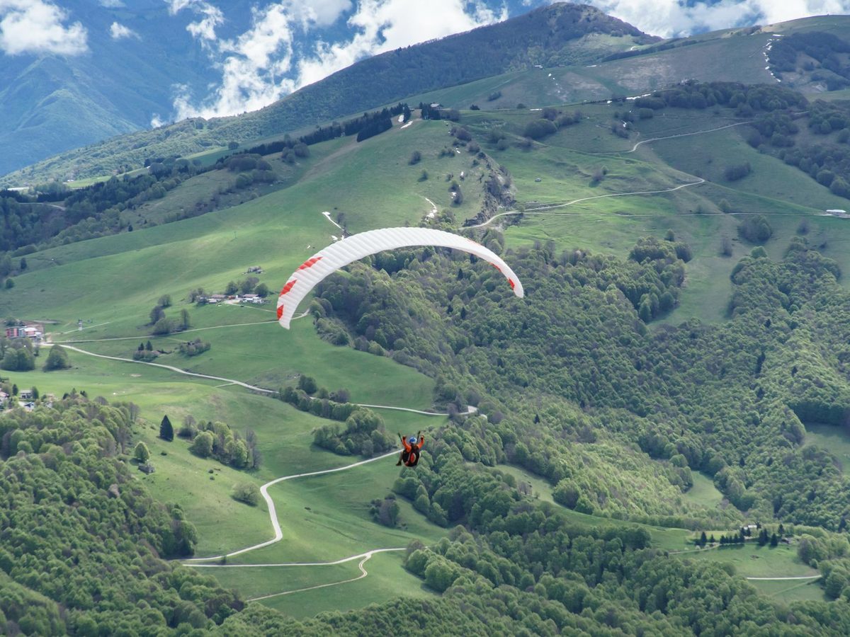 A paraglider over the Monte Baldo ridge