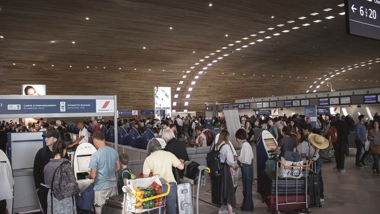 Travellers queueing in an airport terminal