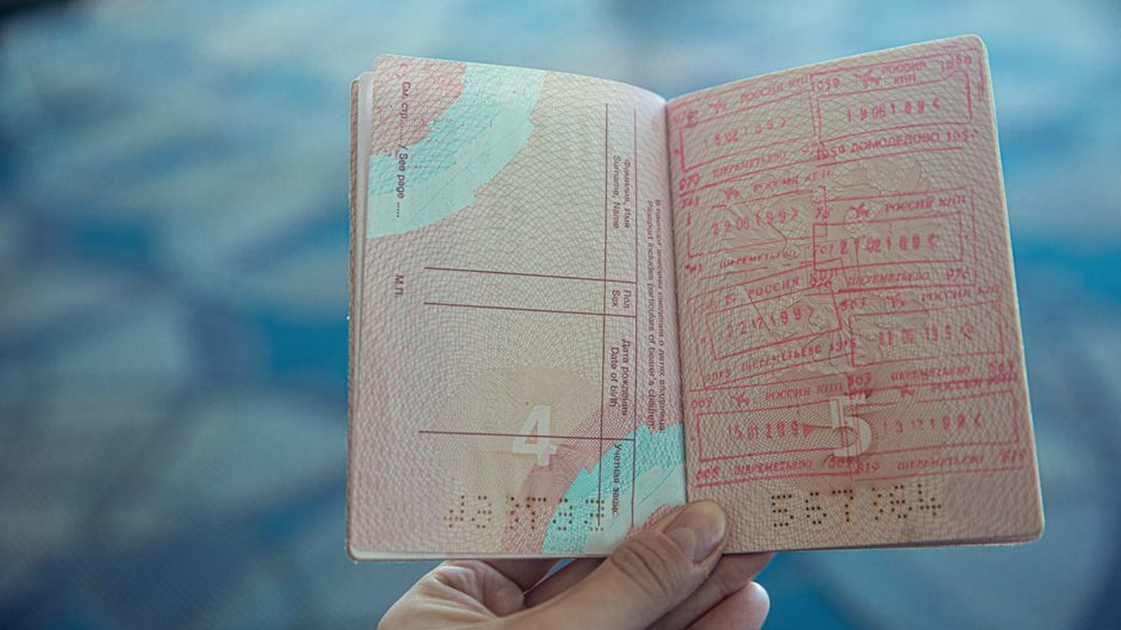 An open passport with border stamps