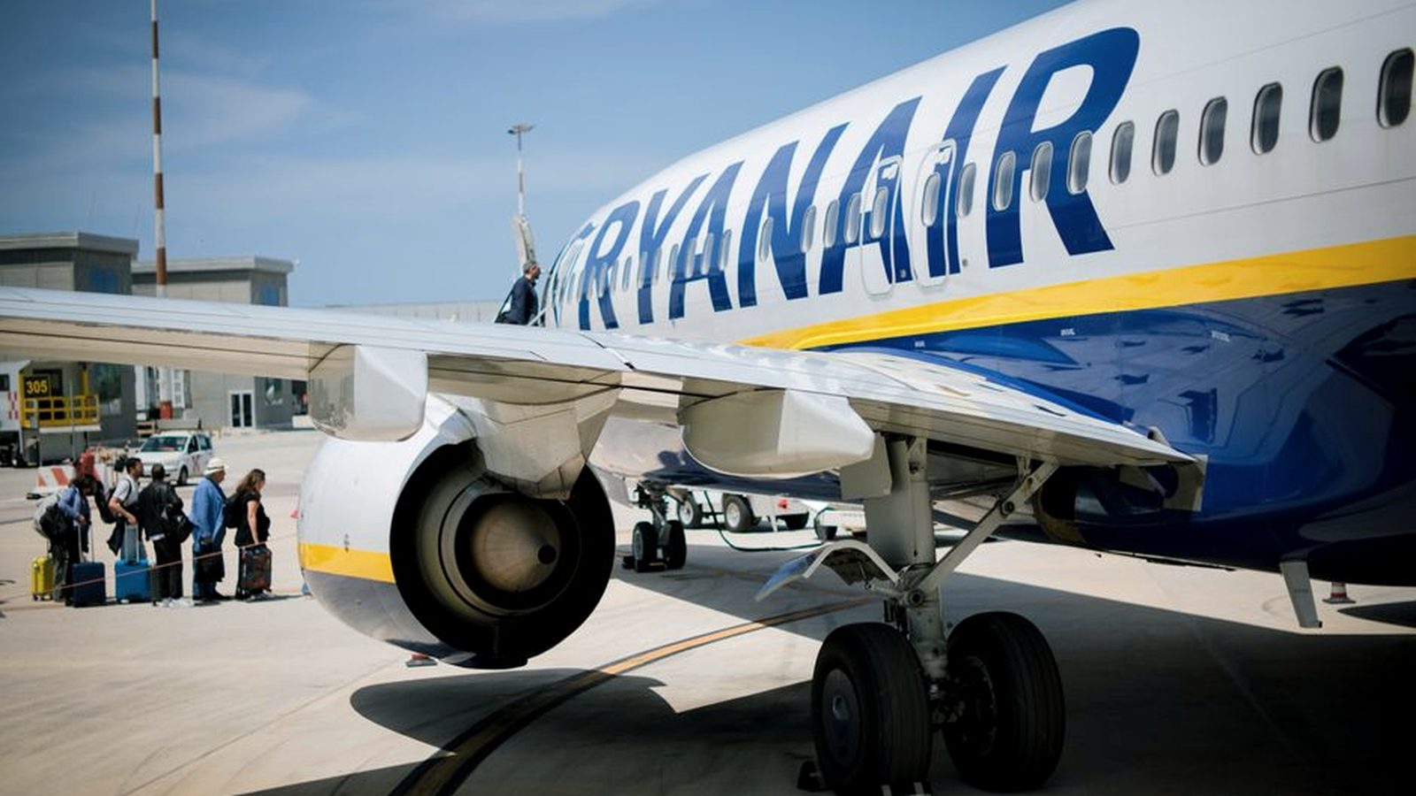 A Ryanair aircraft boarding at an airport gate
