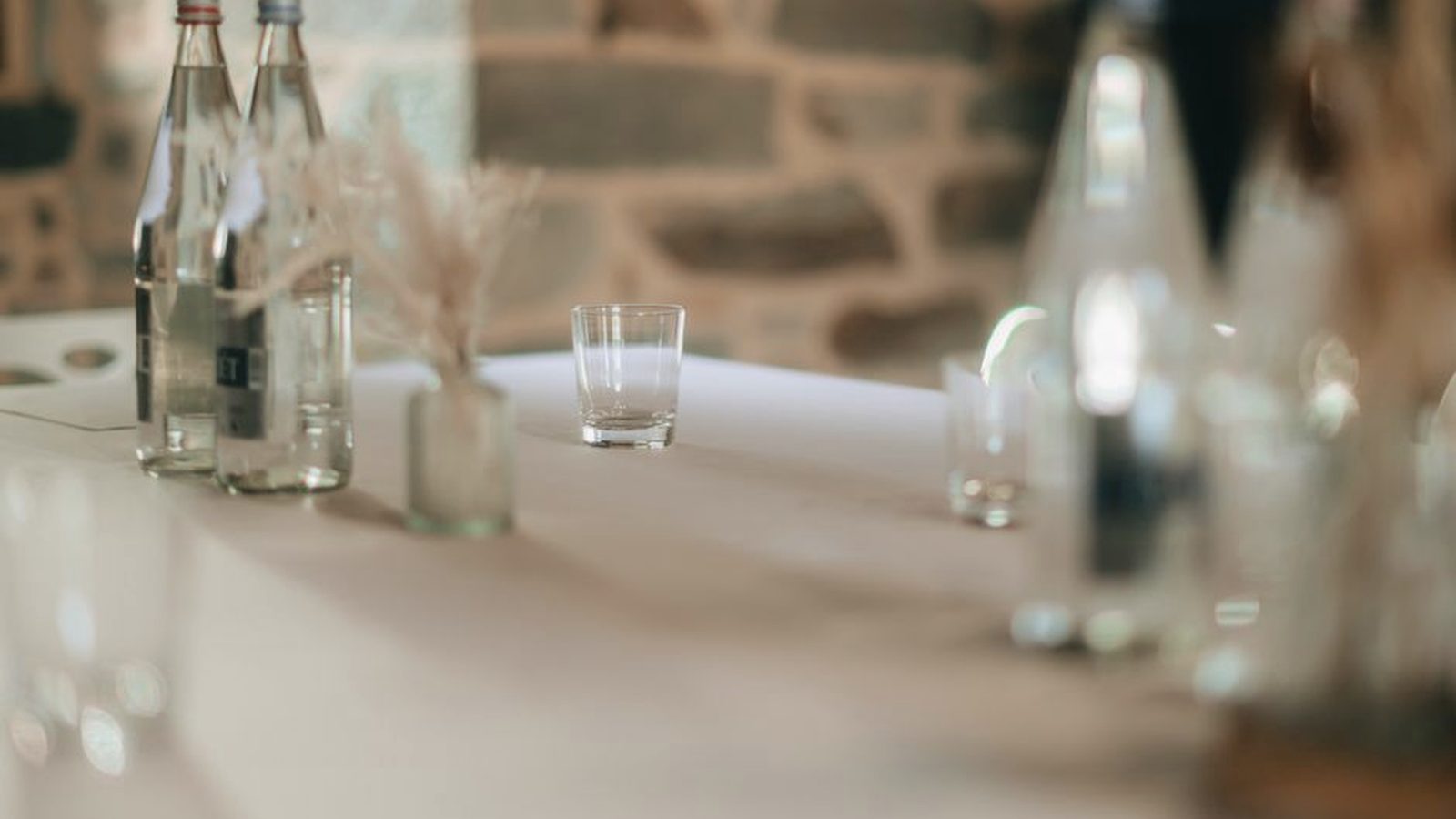 Bottles and glasses of water on a table