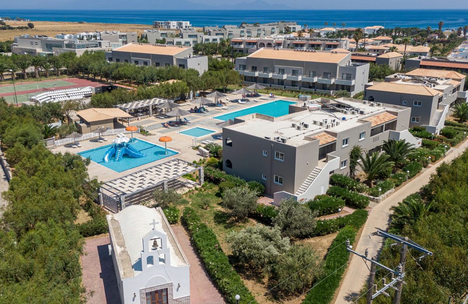Akti Beach Club on the south coast of Kos, its palm-planted grounds running down to a beach and the sea.