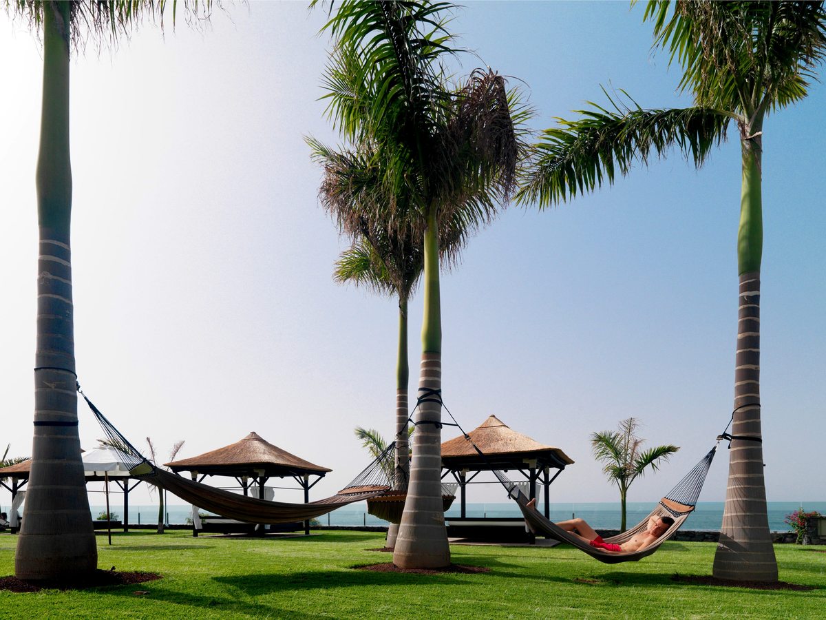 Lawns with tall palms, thatched cabanas and hammocks strung between the trees, the Atlantic beyond.