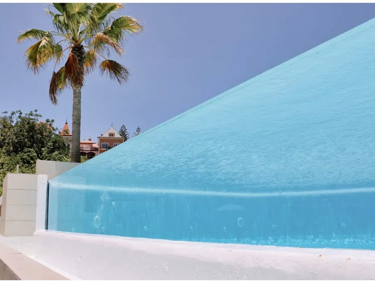A raised, glass-sided pool.