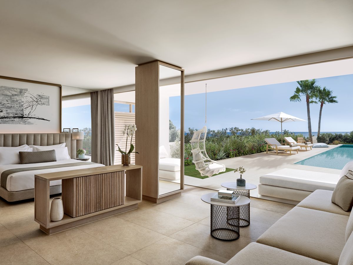 A Deluxe Junior Suite at Ikos Andalusia opening onto its own private pool terrace with the sea beyond.