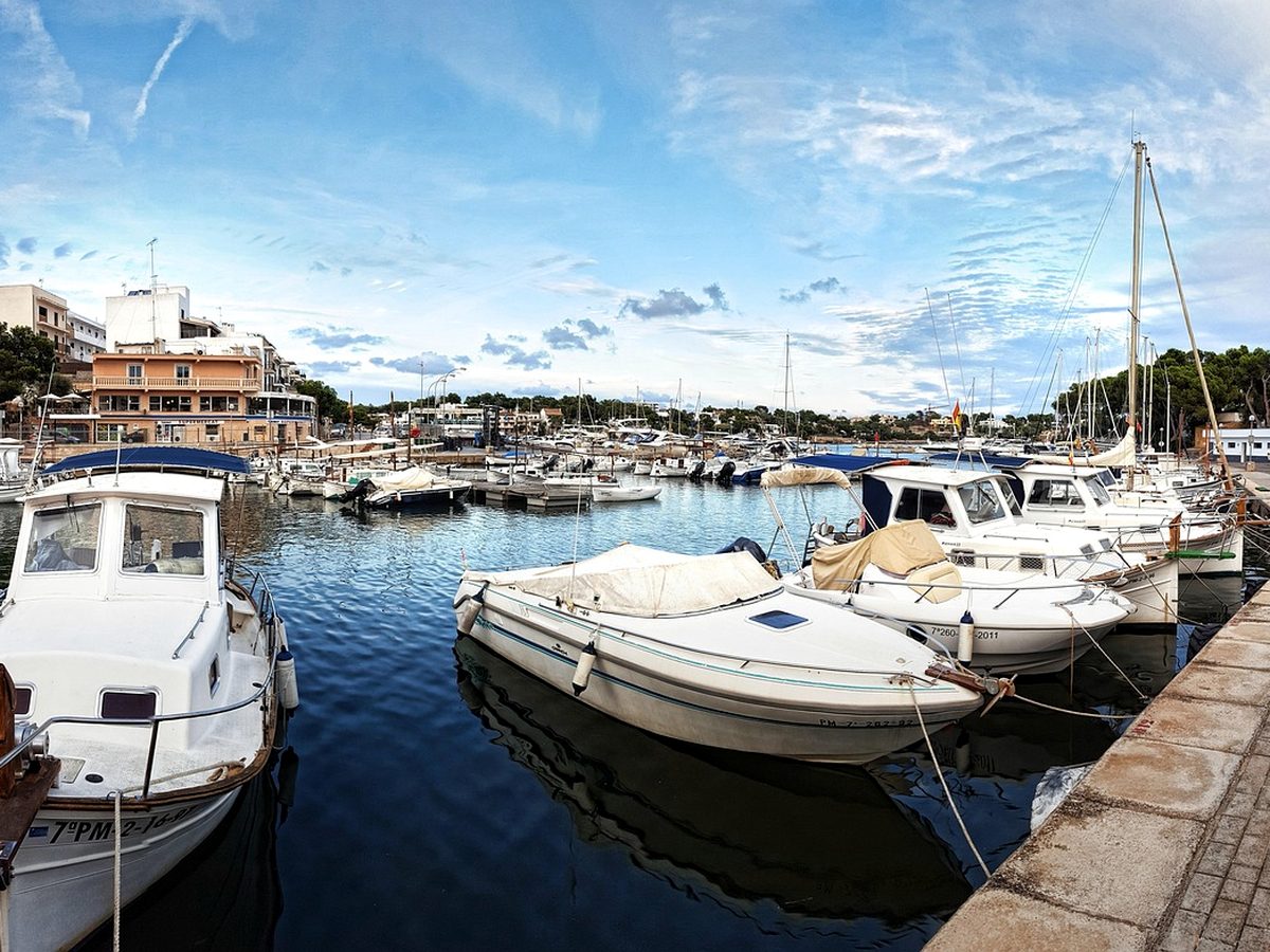 The small working harbour at Portopetro, with fishing and leisure boats moored along the quays.