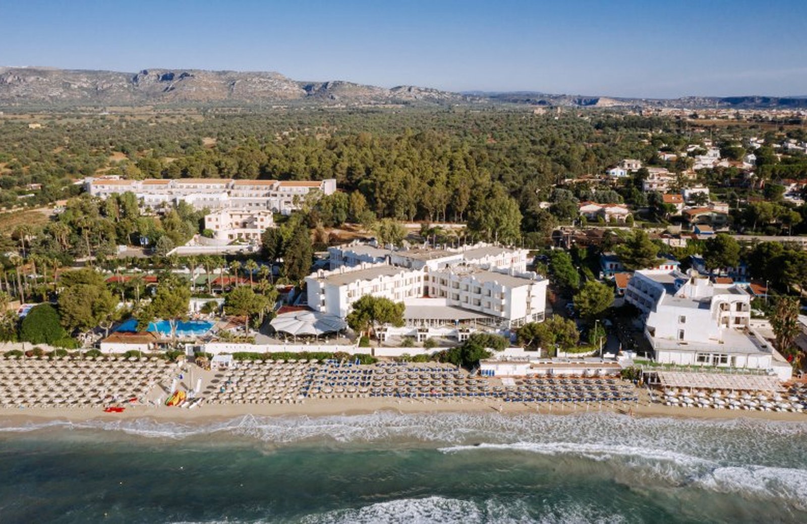 Nicolaus Club Fontane Bianche: a seafront holiday village on the white-sand bay of Fontane Bianche near Siracusa in south-east Sicily, with a pool area opening onto the beach.